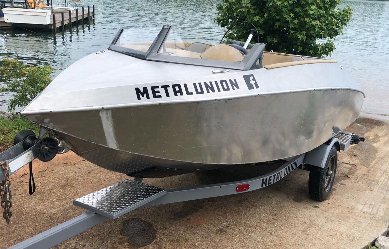 Metal Union Marine mini jet boat ready to enter the lake from the boat ramp.
